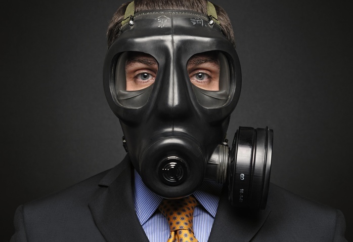 Businessman wearing a gas mask