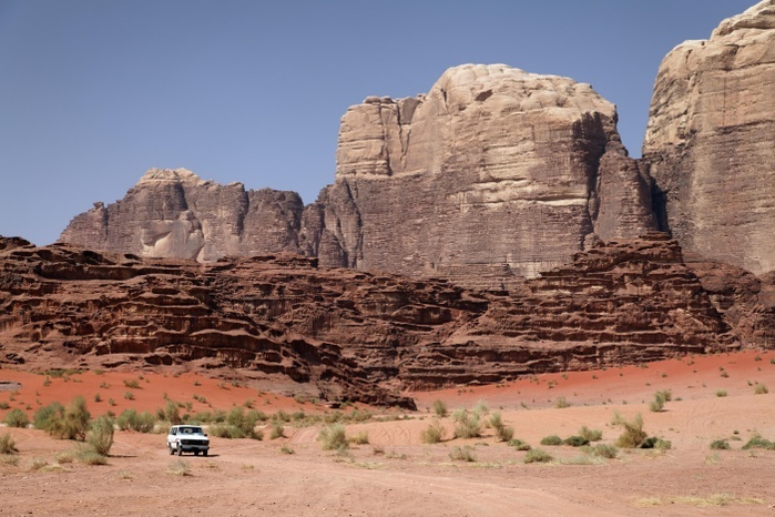 Jordan Off road vehicle in front of mountains, vast plains and red sand in the desert, Wadi Rum, Hashemite Kingdom of Jordan, Middle East, Asia Photo by Norbert Probst