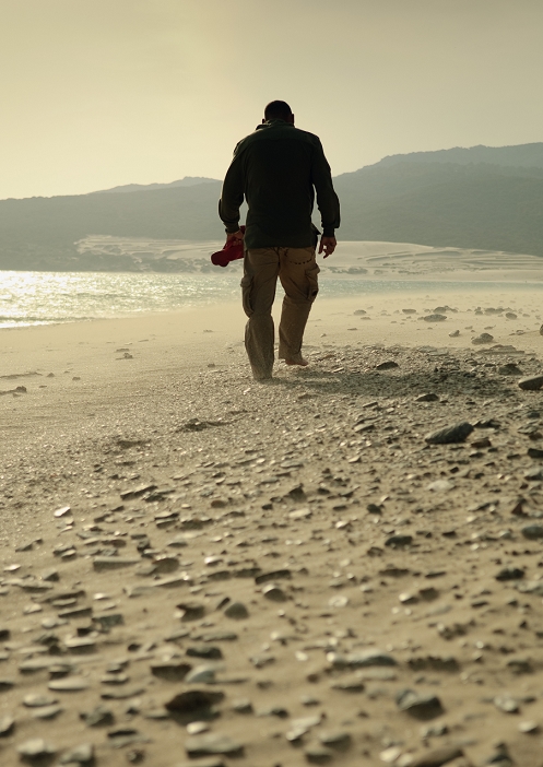 Man walking on a rocky beach