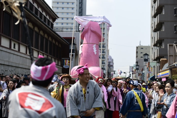 Japan Festival Phallus KAWASAKI, JAPAN   APRIL 7: Festival participants carry a large pink phallic shaped  Mikoshi   portable shrines  during the annual Kanamara Matsuri   The fertility festival, originated from prostitutes who wished to pray for good The fertility festival, originated from prostitutes who wished to pray for good business and protection from sexually transmitted diseases, nowadays, festival goers celebrates for fertility, relationships and for safe sex Attracted with Tens of thousands festival goers including tourists, people can buy penis shape candies, key chains, trinkets, pens, chocolates and even toy glasses with Attracted with Tens of thousands festival goers including tourists, people can buy penis shaped candies, key chains, trinkets, pens, chocolates and even toy glasses with a plastic penis nose. 