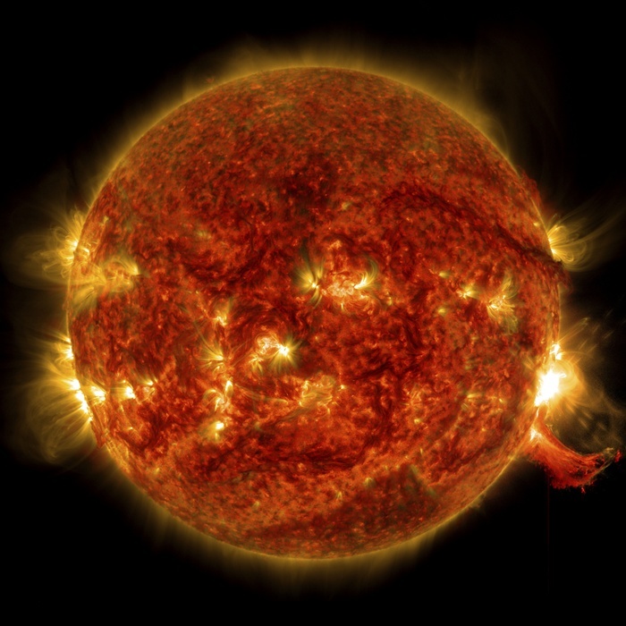 Active Sun and solar flare, SDO ultraviolet image Active Sun and solar flare, Solar Dynamics Observatory  SDO  ultraviolet image. The solar flare is the bright flash at centre right, with a burst of solar material erupting into space below it. The SDO is an Earth orbiting spacecraft launched in 2010 by NASA and used to observe the Sun. Here, the Sun and its atmosphere  not seen in visible light  is seen in a view that combines ultraviolet wavelengths of 131, 171 and 304 angstroms, obtained with the Atmospheric Imaging Assembly  AIA  sensor. This flare occurred on 2 October 2014. It was classified as an M7.3 flare. M class flares are one tenth as powerful as the most powerful flares, which are designated X class flares. For a close up view of the flare, see image C045 6032. Photo by NASA SDO SCIENCE PHOTO LIBRARY