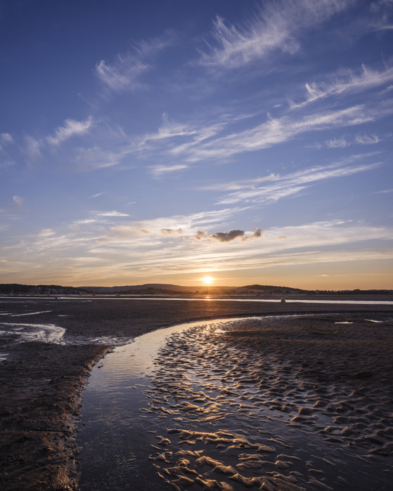 Looking at the setting sun across the Exe estuary towards Starcross from Exmouth, Devon, UK Looking at the setting sun across the Exe estuary towards Starcross from Exmouth, Devon, England, United Kingdom, Europe, Photo by Baxter Bradford