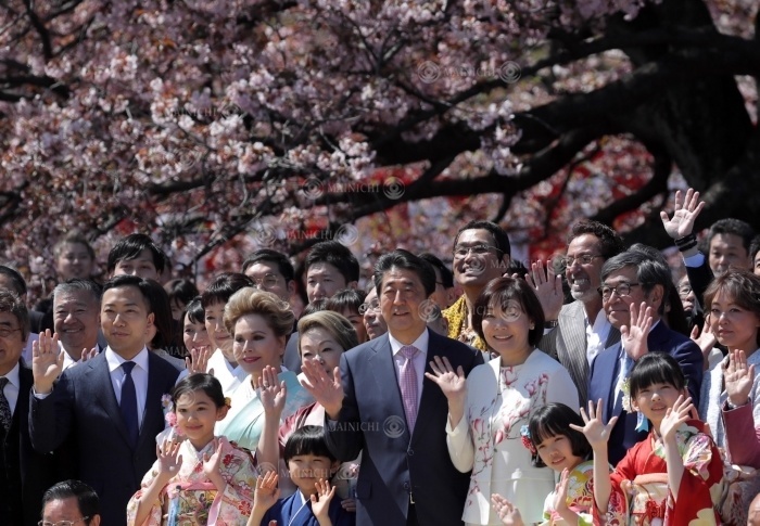 Prime Minister Shinzo Abe and his wife  center right  pose for a photo with guests at the  Cherry Blossom Viewing Party. Prime Minister Shinzo Abe and his wife  center right  pose for a commemorative photo with invited guests at the  Cherry Blossom Viewing Party  at Shinjuku Gyoen in Shinjuku Ward, Tokyo, April 13, 2019  photo by Shinnosuke Kiyatake .
