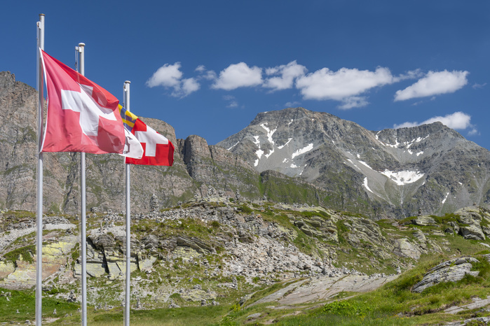 Swiss flags on the San Bernardino pass, Mount San Bernardino, Graubunden, Switzerland. Swiss flags on the San Bernardino pass, Mount San Bernardino, Graubunden, Switzerland.
