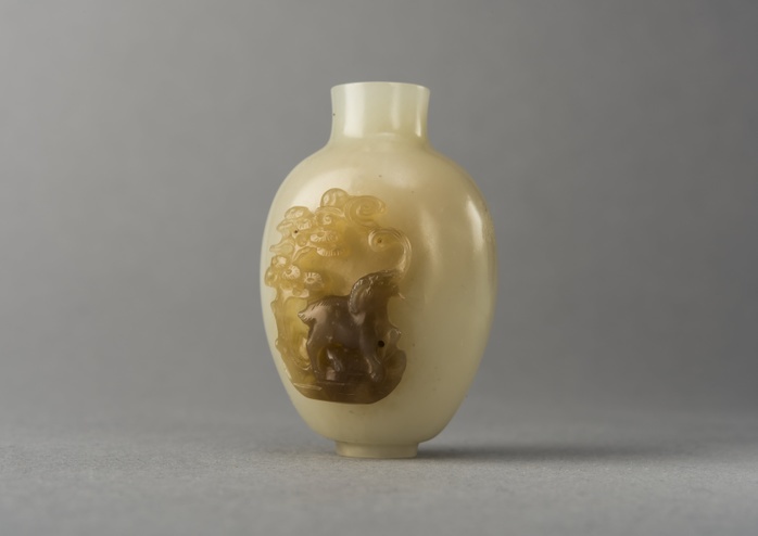 Jade snuff bottle with raised carving of animals, China, Qing dynasty, 1644 1911. Creator: Unknown. Jade snuff bottle with raised carving of animals, China, Qing dynasty, 1644 1911. Jade snuff bottle with high relief decoration on both sides  one side shows a ram beneath a tree and clouds, the other is a monkey on the back of a horse beneath a tree. Small ring foot.