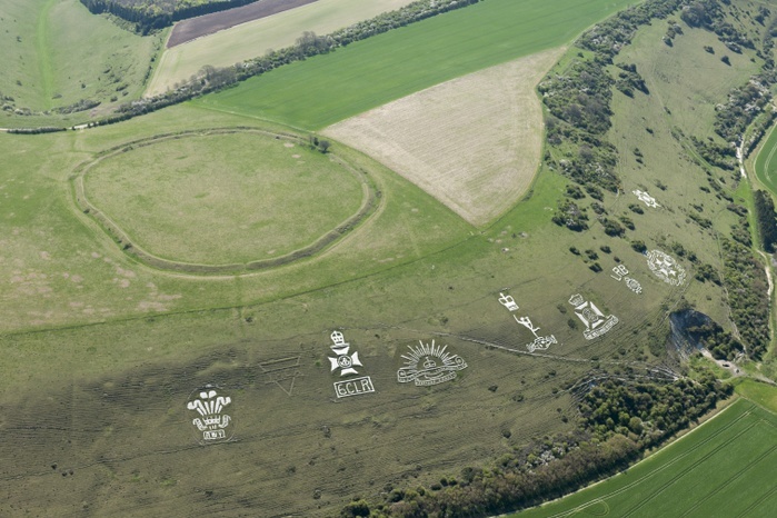 Chalk military badges and Chisenbury Camp univallate hillfort, Fovant Down, Wiltshire, 2015. Creator: Historic England Staff Photographer. Chalk military badges and Chisenbury Camp univallate hillfort, Fovant Down, Wiltshire, 2015. British Army units waiting to be shipped to the Western Front during the First World War carved their regimental badges into the chalk hillsides of Wiltshire while garrisoned nearby.