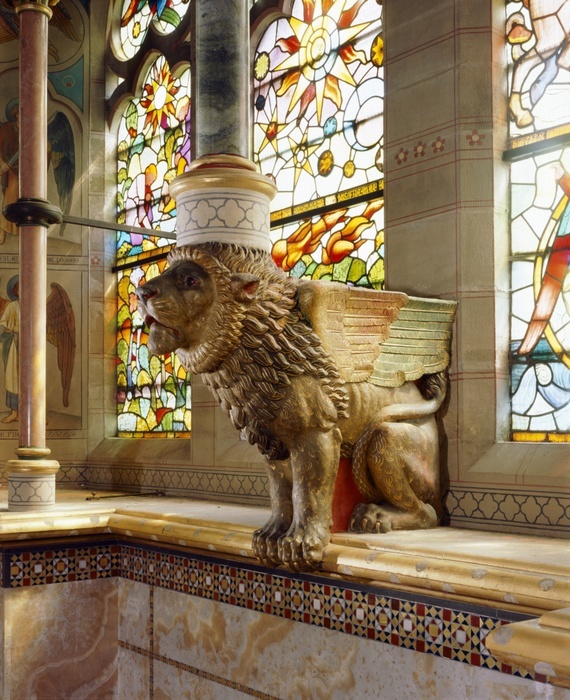 St Mary's Church, Studley Royal, North Yorkshire, c2000s(?). Winged Lion of Judah in the sanctuary supporting one of the double tracery shafts in front of the stained glass window. St Mary's Church was designed by William Burges in the 1870s.