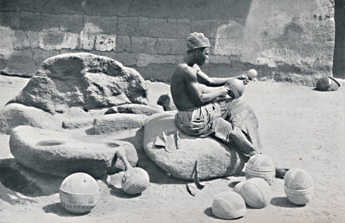 A Yoruba man engraving clay bowls and water jars, Lagos hinterland, Southern Nigeria, 1912. From The Living Races of Mankind, Vol. II. [Hutchinson & Co, London, 1912].