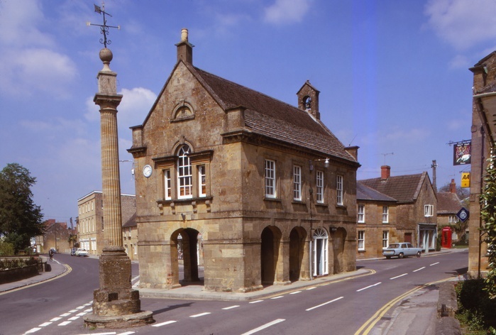 18th Century Market Hall and Cross on Roman Column with Sundial, Martock,  Somerset, 20th century. 18th Century Market Hall and Cross on Roman Column with Sundial, Martock,  Somerset, 20th century. Martock was known in the Domesday Book of 1086 as Mertoch, it is a large village and historic market town. The hamstone Market House on Church Street was built around 1753, it is a Grade II listed building.