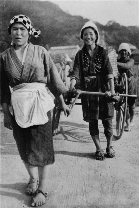 'Three generations of women moving a cart with grandmother at the rear, pushing', c1900, (1921). From Mysterious Japan, by Julian Street. [Doubleday, Page & Company, New York & Toronto, 1921]