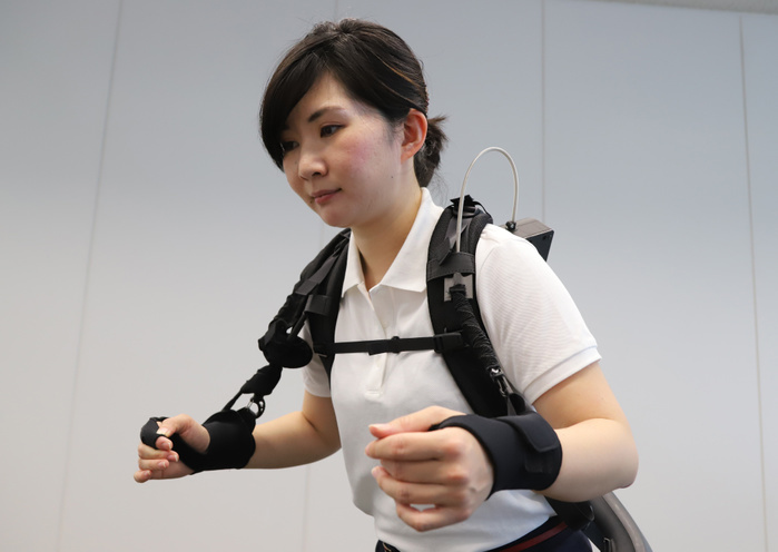 Panasonic s subsidiary ATOUN demonstrates power assist suit May 17, 2019, Tokyo, Japan   Japanese electronics giant panasonic s robot venture ATOUN employee demonstrates their power assisted suit Powered Wear with newly developed arm assisted parts which helps to lift a heavy object at Panasonic s Tokyo office on Friday, May 17, 2019. ATOUN developed Powered Wear last year to assist user s back to carry heavy object for the workers of delivery, airports, construction sites and in the farm.     Photo by Yoshio Tsunoda AFLO 