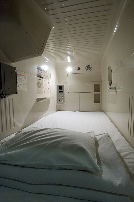 Japan Interior view of single person sleeping compartment at capsule hotel in Osaka, Japan, Asia