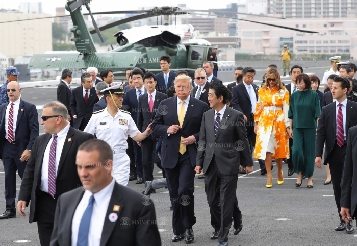 U.S. President Trump and Japanese Prime Minister Shinzo Abe  front center  chat on the deck of the Maritime Self Defense Force destroyer  Kaga  after giving instructions to Maritime Self Defense Force officers and U.S. military personnel in Japan. U.S. President Trump and Japanese Prime Minister Shinzo Abe  front center  chat on the deck of the Maritime Self Defense Force destroyer KAGA after giving instructions to Maritime Self Defense Force officers and U.S. military personnel in Japan. In the back right are his wife Melania and wife Akie at the Maritime Self Defense Force base Yokosuka in Yokosuka, Kanagawa Prefecture, May 28, 2019  photo by Yuki Miyatake .