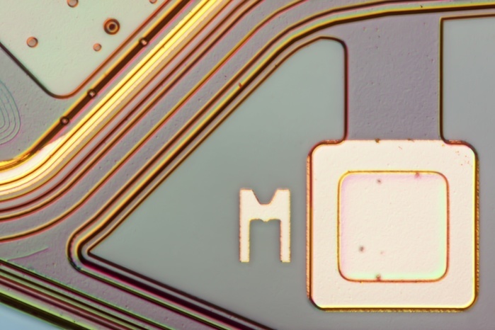Smartphone MEMS microphone, light micrograph Light micrograph of a MEMS  MicroElectroMechanical System  microphone wafer. MEMS microphones are installed in nearly all modern smartphones. The image shows a detailed view of the MEMS wafer, you can see a testpin on the wafer of the MEMS unit. The MEMS is mounted together with the amplifier wafer in the small housing. Microscopic contrast technique: Incident differential interference contrast. Magnification: 200x when printed 10 centimetres wide.
