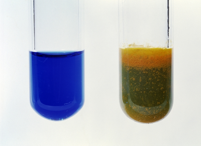 Fehling's reaction. Fehling's reagent (blue, left) reacts with aldehydes (such as ethanal, CH3CHO, right) to form an orange precipitate.