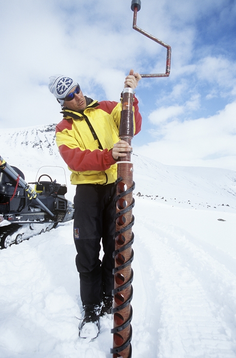 . Glaciologist drilling an ice core using a PICO hand coring drill/auger. This lightweight portable drill was developed by the Polar Ice Coring Office (PICO) at the University of Nebraska, Lincoln, USA. It is designed to be used in inaccessible areas, obviating the need for a full-scale drilling operation. The ice cores taken will have their densities (and hence water content) measured, allowing the amount of winter snow accumulation to be calculated. This is then offset against mass loss during the summer melt to provide the mass balance of the region's glaciers. Mass balance provides important insight into the effects of climate change. Photographed in Swedish Lapland. MODEL RELEASED