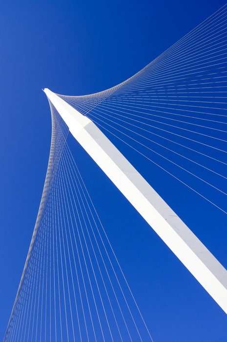 Chords Bridge, Jerusalem. Detail of the suspension system of Chords Bridge in Jerusalem, Israel, against a bright blue sky. The side spar, cable stayed bridge, designed by Spanish architect and engineer Santiago Calatrava, carries the Jerusalem Light Rail Red Line across a road intersection near the central bus station. The bridge opened in 2008 and the Red Line began using it in 2011.