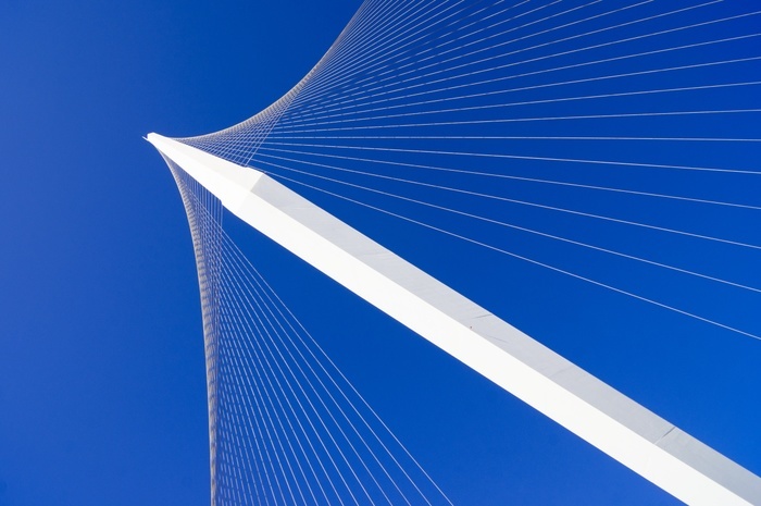 Chords Bridge, Jerusalem. Detail of the suspension system of Chords Bridge in Jerusalem, Israel, against a bright blue sky. The side spar, cable stayed bridge, designed by Spanish architect and engineer Santiago Calatrava, carries the Jerusalem Light Rail Red Line across a road intersection near the central bus station. The bridge opened in 2008 and the Red Line began using it in 2011.