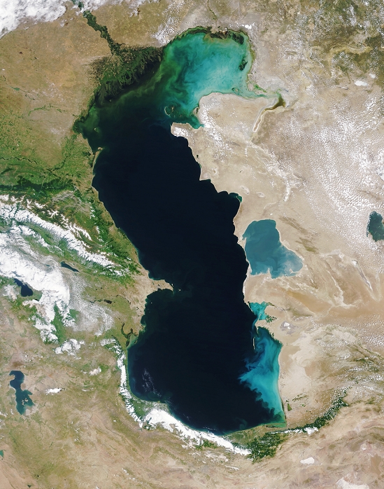 Caspian Sea. Satellite image of the Caspian Sea. Kazakhstan, Turkmenistan, Iran, Azerbaijan and Russia share its shores. The Caspian Sea is the world's largest inland sea. It has no outflowing rivers, and loses water only by evaporation. It is fed by several rivers including the Ural (top centre) and the Volga (top left). Fertilizer runoff from agricultural land has resulted in eutrophication (nutrient enrichment) of the sea's water, which in turn has led to algal growth (green swirls, top). Shallow water is blue, deep water is black. This image was obtained by the Moderate Resolution Imaging Spectroradiometer (MODIS) on the TERRA satellite on 11 June 2003.