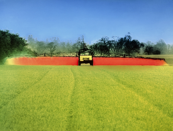 False-colour photograph of a Mercedes Unimog machine spraying either a fungicide or an insecticide onto a cereal crop during Spring.