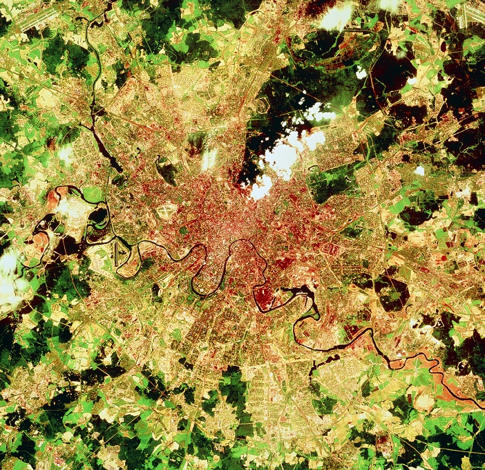 Moscow, seen from space. Satellite view of Moscow, capital city of Russia. The city sits on the banks of the Moskva River. The older parts of the city are seen as a reddish brown area at centre. This is surrounded by pale-coloured suburbs. In many suburban parts are collections of rectangular shapes - large residential tower blocks formed into local groups or 'microregions'. These blocks house the bulk of Moscow's population. Moscow's international airport, Sheremetyevo, is seen at top left. At bottom left and top right are airports servicing the extensive domestic network. The data for this image were gathered by a Landsat satellite in 1984.