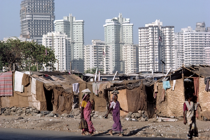 High-rise buildings form the background to this view of shanty, slum-dwellings at Nariman Point, Bombay.