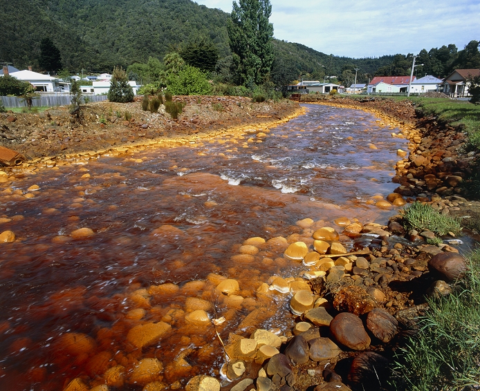 River pollution. Discoloured, polluted water of the Queen River flows past residential housing in Queenstown, Tasmania. This pollution is due to copper mines located upstream. Queenstown has been a mining centre since 1883. The Queen River is polluted primarily by acid drainage from the old mines. Acid drainage must be reduced by more than 95% for life to return to the river. Polluted water from the Queen River flows into the King River which is arguably the most polluted river in Australia.
