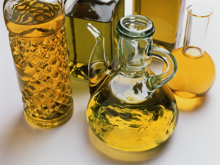 Olive oil. Bottles of oil squeezed from olives (Olea europaea).