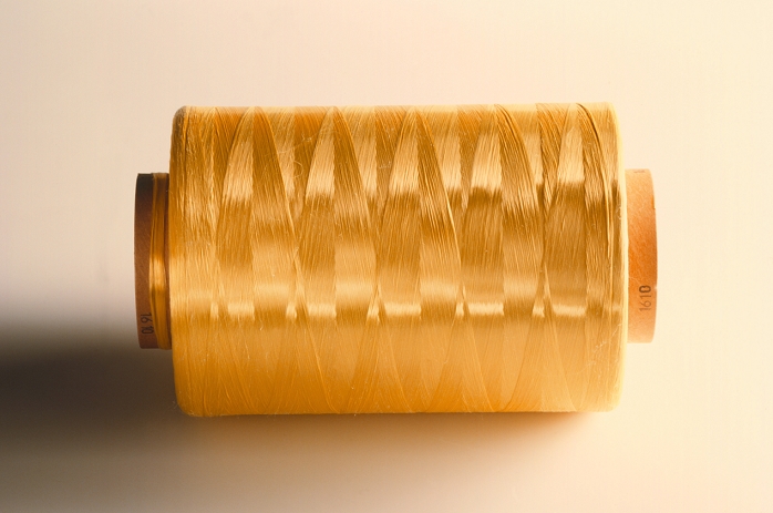 Reel of thread. Reel with aramide thread wound around it. Aramide is a strong, synthetic material made from mineral oil and is used to make Kevlar. Kevlar fibres are used to make bullet-proof clothing and reinforce various materials.