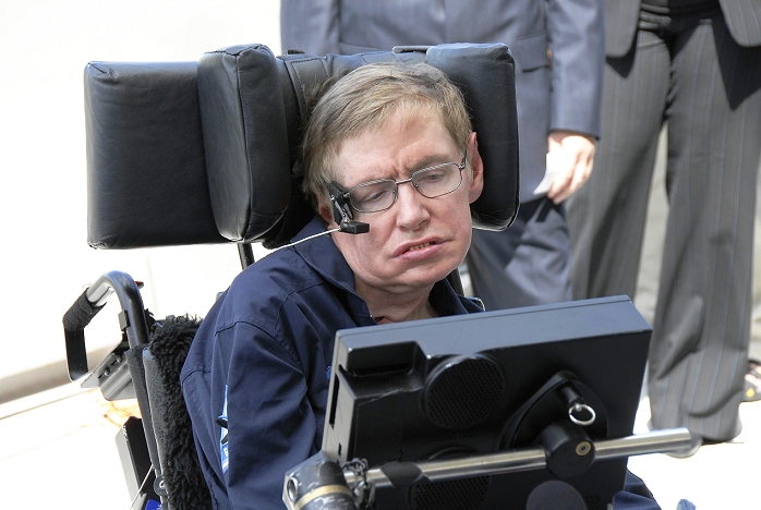 Stephen Hawking, (born 1942) British theoretical physicist, at Kennedy Space Center, Florida, USA, 26 April 2007. He is wearing a flight suit as he prepares for a freefall flight on board a modified Boeing 727 jet owned by the Zero Gravity Corporation. The jet completes a series of steep ascents and dives that create short periods of weightlessnes due to freefall. During his flight Hawking experienced 8 such periods. In 1963 Hawking was diagnosed with amyotrophic lateral sclerosis (ALS), a form of motor neurone disease, which has left him wheelchair-bound. During the flight Hawking floated free in the aircraft. Hawking is best known for his work on cosmology and black holes, and writing the popular science book A Brief History of Time (1988).