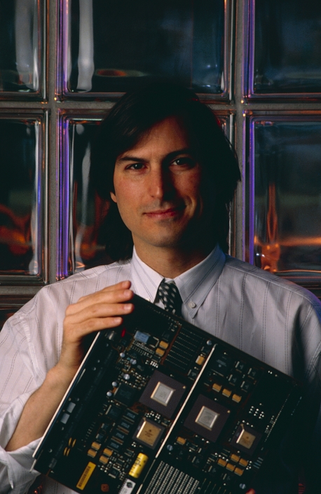 Steve Jobs  unknown date  Steven Paul Jobs, computer entrepreneur, photographed holding a circuit board in the automated factory of NeXT computers, Fremont, California. In 1976, at the age of 21, Jobs co  founded Apple Computers with Steve Wozniak. In 1985, after Apple had become a billion dollar company, Jobs was forced out. His latest venture, the NeXT computer, is similar in appearance to a conventional personal computer, but performs like a workstation linked to a mainframe machine. Like most other workstations, it uses the UNIX operating system to run a powerful array of processor chips   an optical memory system. The NeXT computer was launched in October 1988.