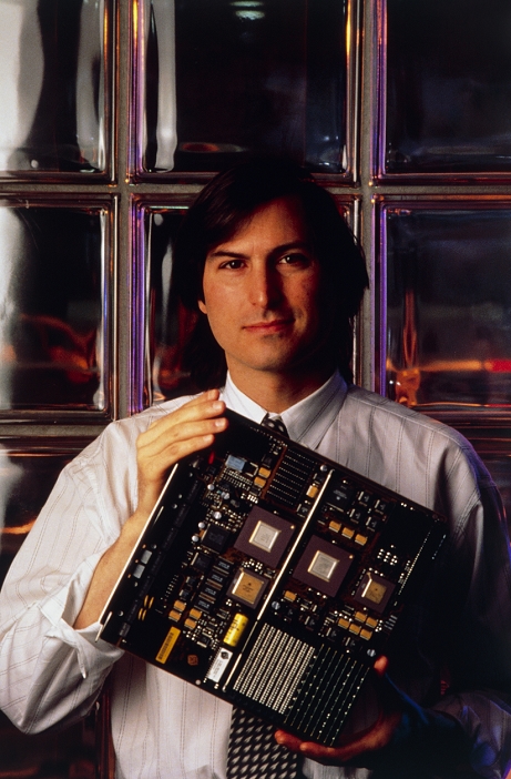 Steve Jobs  date of shooting unknown  Steven Paul Jobs, computer entrepreneur, photographed in the automated factory of NeXT computers, Fremont, California. In 1976, at the age of 21, Jobs co founded Apple Computers with Steve Wozniak. In 1985, after Apple had become a billion dollar company, Jobs was forced out   only to begin plans to launch his next venture, the NeXT computer. Similar in appearance to a conventional personal computer, the NeXT performs like a workstation linked to a mini  or mainframe machine. Like other workstations, it uses the UNIX operating system to run a powerful array of processor chips   an optical memory system. The NeXT computer was launched in October 1988.