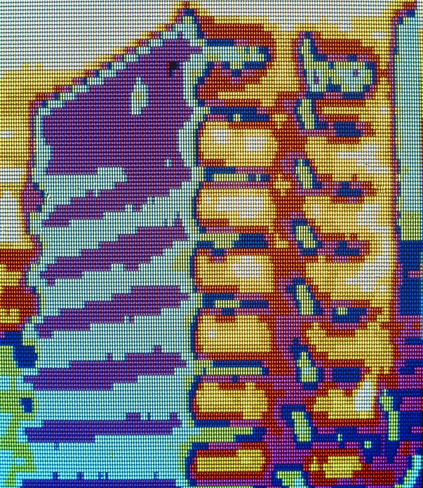 Thermogram of an office block showing the distribution of temperature across the exterior surface of the building. The sun has heated the the right side of the building, which is colour coded in the warmer yellow & red colours. The front of the building is not affected by the sun and appears in the cooler colours of green & purple. See H584/051 for ordinary 35mm photograph. Original is 6x7 cm h584/039.