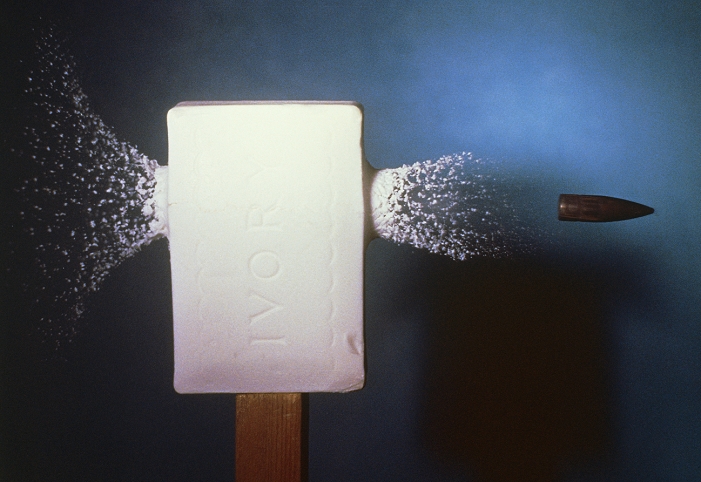 High speed photograph of a .30 calibre bullet passing through a bar of ivory soap.