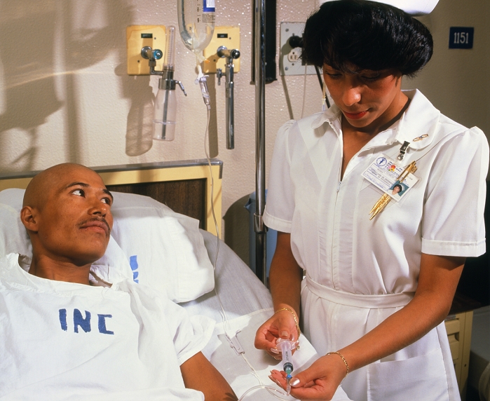 . A nurse administering an anti- emetic drug, to a patient about to undergo chemotherapy for cancer. Nausea and vomiting are often associated with cytotoxic chemotherapy and radiotherapy. The drug is usually given by intravenous infusion just before therapy, and by tablets thereafter. Severely emetogenic therapy may require additional intravenous dosages. MODEL RELEASED