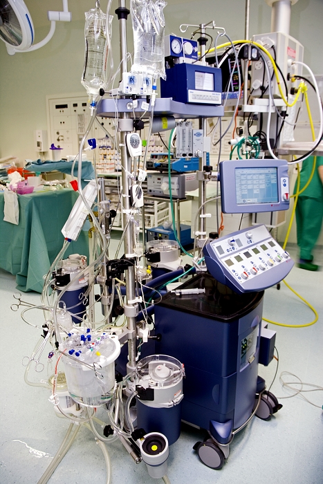 . Heart-lung machine being prepared for cardiac surgery. This machine takes over the function of the heart and lungs while the heart is temporarily stopped during surgery, allowing more time to operate. The machine oxygenates the blood and removes carbon dioxide. It also heats the blood to the correct temperature before pumping it back into the patient's body. MODEL RELEASED