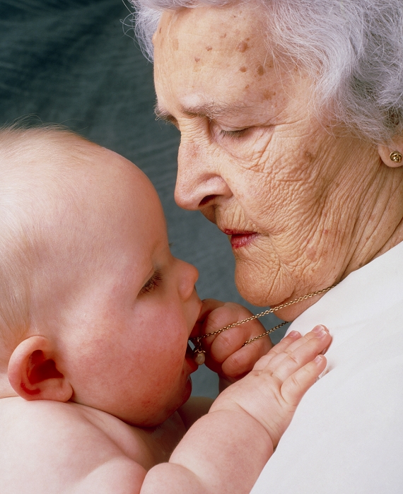 . Grandchild. Portrait of an elderly grandmother holding her infant grandchild. MODEL RELEASED
