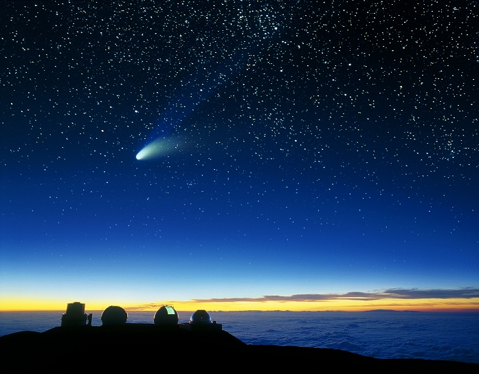 Comet Hale Bopp  Date of photograph unknown  Mauna Kea telescopes and comet. Image taken at dusk of telescope domes on Mauna Kea, with comet Hale Bopp seen in the sky. The telescopes are from left to right: Subaru, Keck I and II, NASA infrared facility. Comet Hale Bopp was one of the brightest comets of the 20th century. Here, its two tails are seen. The gas or  ion  tail  blue  consists of ionized glowing gas blown away from the comet head by the solar wind. The dust tail  white  consists of grains of dust pushed away from the comet head by the radiation of sunlight. Comet Hale Bopp was seen in early 1997. Mauna Kea, an extinct volcano in Hawaii, has many telescopes on its 4,205 metre high summit.