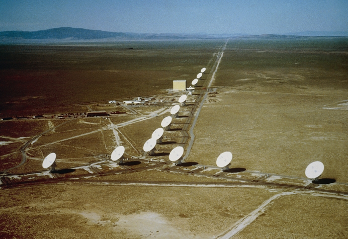 *** THIS PICTURE MAY NOT BE USED TO STATE OR IMPLY  THE ENDORSEMENT BY NRAO, AUI OR NSF OF ANY COMPANY  OR PRODUCT *** Aerial view of the Very Large Array (VLA) radio telescope near Socorro, New Mexico. The VLA is the world's largest radio telescope array. It consists of 27 dish antennae, each 25 m in diameter, which can be moved to various positions along the arms of a Y-shaped railway network. Two of the arms are 21 km long, the third is 19 km. The 27 antennae are spread along the full length of the arms for high-detail mapping of small, bright radio sources. Maps of larger, faint sources are made with the antennae brought together on short, 0.6 km arms. Intermediate configurations have arm lengths of 1.9 (seen here) and 6.4 km. The yellow structure is the Antenna Assembly Building. This picture may not be used to state or imply the endorsement by NRAO, AUI or NSF of any company or product.