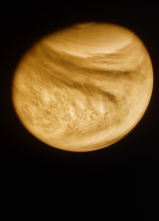 Photo of Venus, taken by the Pioneer-Venus Orbiter, showing its turbulent, cloudy atmosphere. The clouds move rapidly around the planet from east to west (right to left) at a speed of approximately 100 metres per second (220 miles per hour). Bright cloud areas wrap around both poles. The small mottled features at the equator (upper centre) appear to be convective cells caused by the Sun's heating of the atmosphere. The Pioneer- Venus Orbiter was used to study Venus, from its orbit around the planet, for over two years from December 4th, 1978.