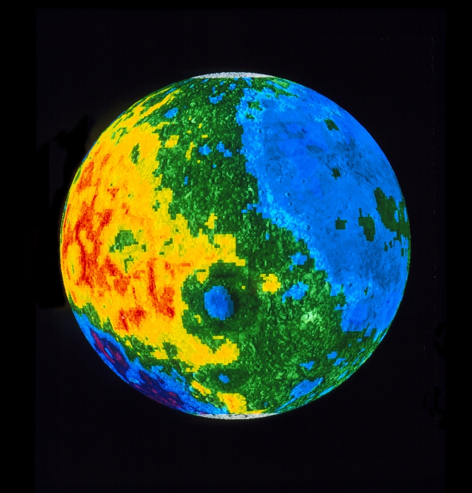 Lunar topography. Coloured topographic map of the western hemisphere of the Moon. In this image the right hand side is Earth-facing, whilst the left is on the Moon's far side. The border between blue and green represents the mean radius of the Moon, with dark blue and magenta the lowest areas and yellow and red the highest. The image clearly shows the difference between the near side with its oceans and the mountainous far side. Just below centre is the Mare Orientale impact basin (blue circle), and at bottom left is the deep SP- Aitken Basin. The data for this image were gathered by the Clementine satellite in 1994.