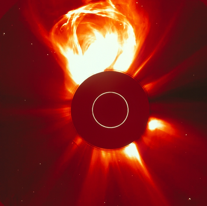 coronal mass ejection Solar eruption. SOHO  Solar and Heliospheric Observatory  image of a huge coronal mass ejection  CME  from the Sun. The disc of the Sun has been obscured to prevent the image from being over  exposed. The white circle at centre represents the size of the Sun. A CME is an energetic eruption from the corona, the hot outer layer of the Sun. It is a common event during periods of high solar activity, and consists of charged gas  plasma  travelling at up to 400 kilometres per second. If directed towards Earth, it may cause magnetic storms and aurorae. Image taken by the Large Angle and Spectrometric Coronagraph  LASCO  on the SOHO satellite between the Earth and the Sun.