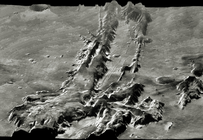 Oblique view of the central region of the giant Valles Marineris canyon system on Mars, computer- processed from Viking spacecraft imagery & topographic maps of the planet. The Valles Marineris is over 3000 km long & up to 8 km deep, dwarfing the Grand Canyon of Arizona. The canyons were formed by a combination of geological faulting, landslides, and erosion by wind and ancient water flows. The central area shown here contains layered deposits which may have been deposited by ancient lakes. The view is looking east, from 30 degrees above the horizon. (Image processing by Alfred McEwen & topographic mapping by Sherman Wu, both at USGS, Flagstaff, Arizona).