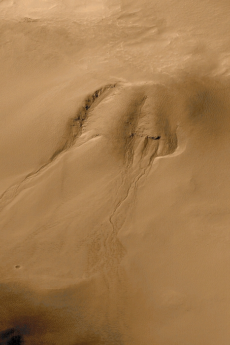 Martian water erosion. Gullies and channels on the surface of Mars thought to indicate the presence of liquid water in its recent history. They are thought to have been formed by groundwater seepage and surface runoff. The lack of small impact craters, common elsewhere on Mars, implies that they are young features. This means that liquid water may still exist just below the surface of Mars, which would provide a viable habitat for life. These features are in the Noachis Terra region in Mars' southern hemisphere. This image, three kilometres wide, was taken by the Mars Orbiter Camera on the Mars Global Surveyor spacecraft orbiting Mars. Data analysed in 2000.