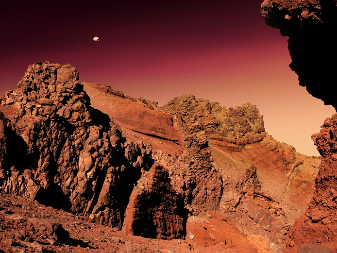 Martian landscape, artwork. Mars is a rocky desert world with no surface water. The red colour of the rocks is due to a high content of iron oxides. The Martian atmosphere, less dense than Earth's, is mostly carbon dioxide. Surface temperatures are well below freezing. Mars has two moons, and the larger and closer moon, Phobos, is seen in the sky at upper left. Phobos is less than 30 kilometres long, and is an irregularly shaped chunk of rock. It only takes 8 hours to orbit Mars, at a distance of less than 10,000 kilometres.
