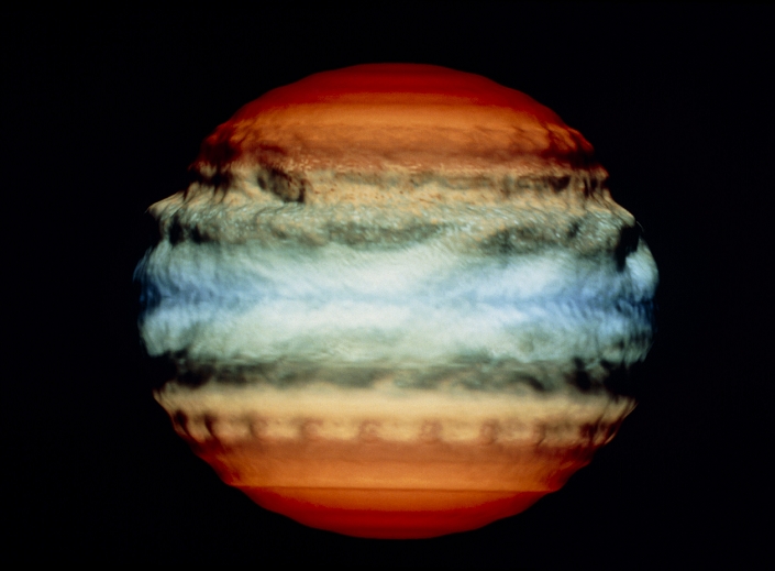 Comet Shoemaker-Levy impact on Jupiter, July 1994. First in a series of five frames from a computer simulation, showing the effect of the impact of a 1-km diameter comet on the atmosphere of Jupiter. The altitude scale in the model is exaggerated, giving the atmosphere a 'lumpy' appearance. This frame shows Day 0, just before the impact occurs. Over 20 1-km or larger fragments from Comet Shoemaker-Levy 9 are due to hit Jupiter on 18-24 July 1994. The comet was broken up by Jupiter's gravity during a close encounter in July 1992.