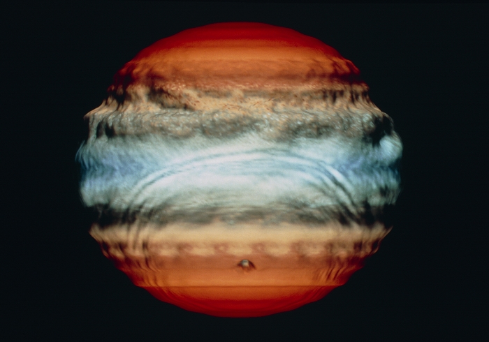 Comet Shoemaker-Levy impact on Jupiter, July 1994. Fourth in a series of five frames from a computer simulation, showing the effect of the impact of a 1-km diameter comet on the atmosphere of Jupiter. The altitude scale in the model is exaggerated, giving the atmosphere a 'lumpy' appearance. This frame shows Day 3, two days after the impact. Large waves are seen in the atmosphere, moving from the point of impact (lower centre) and disrupting the 'bands'. Over 20 1-km or larger fragments from Comet Shoemaker-Levy 9 are due to hit Jupiter on 18-24 July 1994. The comet was broken up by Jupiter's gravity during a close encounter in July 1992.