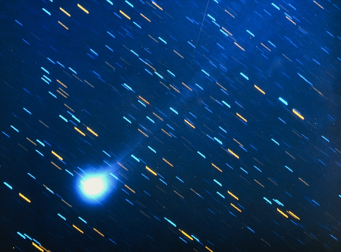 Optical image of the periodic comet Swift-Tuttle (bottom left) taken on November 19th 1992. It has been rediscovered exactly where the astronomer B. Marsden had predicted in 1973. The comet, the debris of which causes the Perseid meteor shower, was telescopically discovered in 1862. The first calculations indicated a period of about 120 years. Marsden recalculated the orbit considering the perturbations caused by the 'rocket effect' of gas escaping from the comet. He proposed a new period of about 130 years and predicted (rightly) its next appearance in 1992. It has been suggested that the Swift-Tuttle comet could hit the Earth in its next return in 2126.