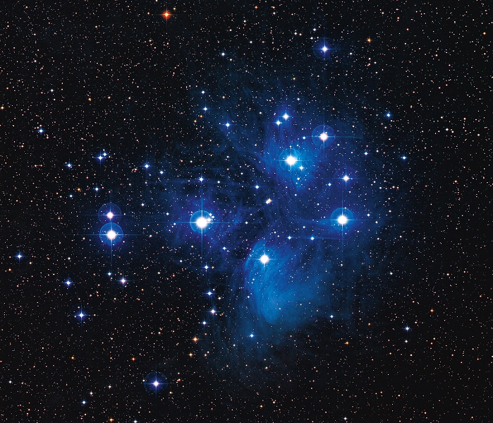 Pleiades. Optical image of the Pleiades star cluster (M45) in the constellation Taurus, the bull. North is at top. This is a cluster of young stars thought to be around 50 million years old. It lies some 400 light years from Earth. Blue reflection nebulae surround some of the stars, which are thought to be the remnants of the gas cloud from which the stars formed.