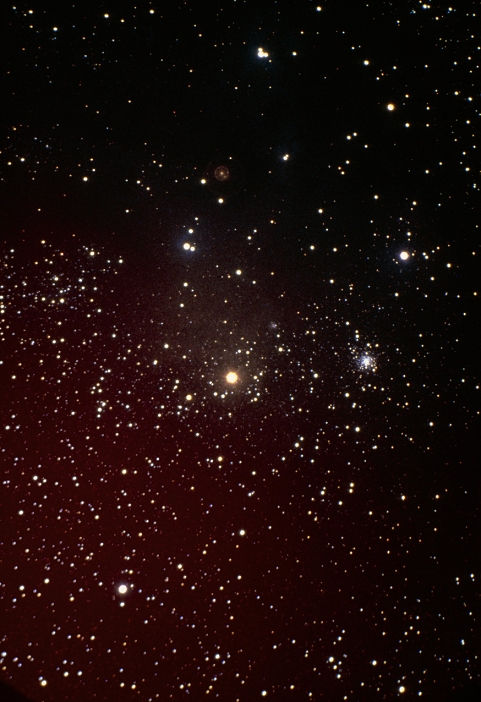 Optical photograph of the red supergiant star Antares (centre), with the M4 globular star cluster (also known as NGC 6121) to its right. Antares is the brightest star in the constellation of Scorpius. It is a first magnitude, distinctly red star whose naked eye appearance is similar to that of Mars - hence its name, which means 'Rival to Mars'. Antares is both a binary star (orbiting an unseen close companion) & a variable one (its brightness varying by about one magnitude in an irregular manner over an average period of 1733 days). 5.5' Schmidt, 8 min. exposure, 28 May 1979.